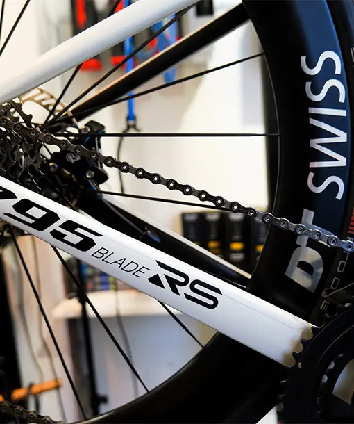 Close-up of a white 795 Blade RS new bike build showing the chain, cassette, and DT Swiss rear wheel.